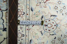 Backside of handmade New Nain rug showing knot structure and weave density