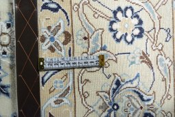 Backside of handmade New Nain rug showing knot structure and weave density