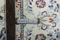 Backside of handmade New Nain rug showing knot structure and weave density