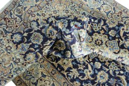 Surface texture of 2000s Nain rug with natural Wool and intricate pattern