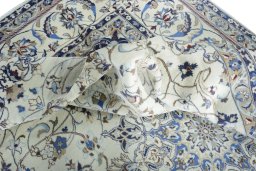 Surface texture of 2000s Nain rug with natural Wool and intricate pattern