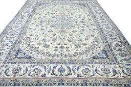 Surface texture of 2000s Nain rug with natural Wool and intricate pattern