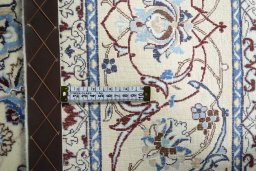 Backside of handmade New Nain rug showing knot structure and weave density