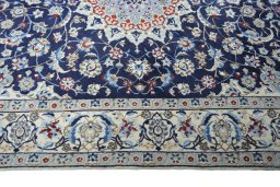 Corner detail of 2000s Nain rug showing border pattern and Wool pile