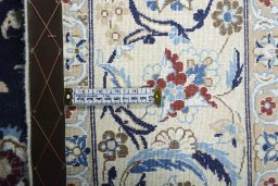 Backside of handmade 2000s Nain rug showing knot structure and weave density