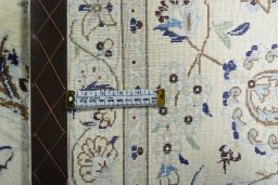 Backside of handmade New Nain rug showing knot structure and weave density