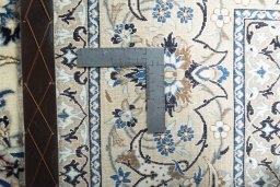 Backside of handmade New Nain rug showing knot structure and weave density