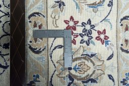 Backside of handmade New Nain rug showing knot structure and weave density