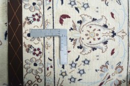 Backside of handmade New Nain rug showing knot structure and weave density