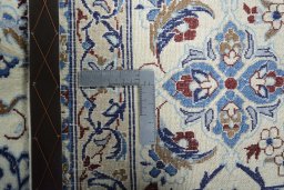 Backside of handmade New Nain rug showing knot structure and weave density