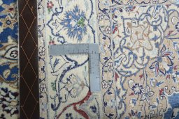 Backside of handmade New Nain rug showing knot structure and weave density