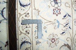 Backside of handmade New Nain rug showing knot structure and weave density