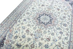 Backside of handmade New Nain rug showing knot structure and weave density