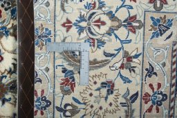 Backside of handmade New Nain rug showing knot structure and weave density