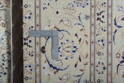 Backside of handmade New Nain rug showing knot structure and weave density