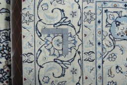 Backside of handmade New Nain rug showing knot structure and weave density