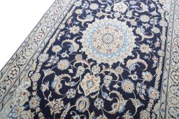 Backside of handmade New Nain rug showing knot structure and weave density