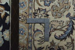 Backside of handmade New Nain rug showing knot structure and weave density