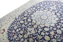 Backside of handmade New Nain rug showing knot structure and weave density