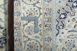 Backside of handmade New Nain rug showing knot structure and weave density