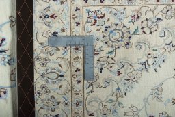 Backside of handmade New Nain rug showing knot structure and weave density