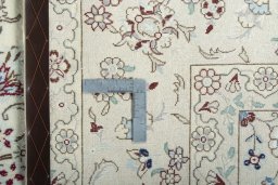 Backside of handmade New Nain rug showing knot structure and weave density