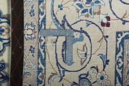 Backside of handmade New Nain rug showing knot structure and weave density