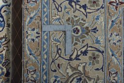 Backside of handmade New Nain rug showing knot structure and weave density