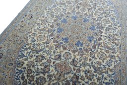 Backside of handmade New Nain rug showing knot structure and weave density