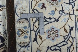 Backside of handmade New Nain rug showing knot structure and weave density