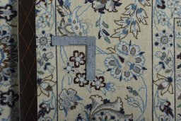 Backside of handmade New Nain rug showing knot structure and weave density