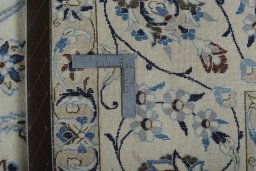 Backside of handmade New Nain rug showing knot structure and weave density
