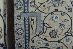 Backside of handmade New Nain rug showing knot structure and weave density