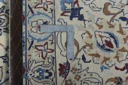 Backside of handmade New Nain rug showing knot structure and weave density
