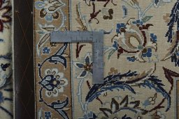 Backside of handmade New Nain rug showing knot structure and weave density