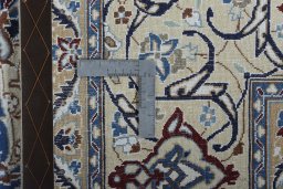 Backside of handmade New Nain rug showing knot structure and weave density