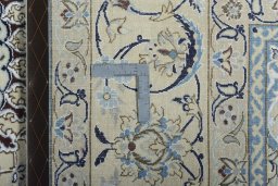 Backside of handmade New Nain rug showing knot structure and weave density