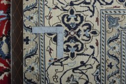 Backside of handmade New Nain rug showing knot structure and weave density
