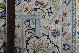 Backside of handmade New Nain rug showing knot structure and weave density