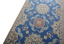 Backside of handmade New Nain rug showing knot structure and weave density