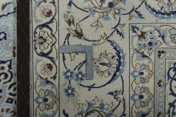 Backside of handmade New Nain rug showing knot structure and weave density