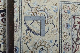 Backside of handmade New Nain rug showing knot structure and weave density