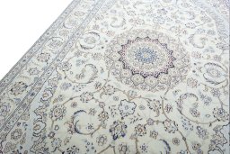 Backside of handmade New Nain rug showing knot structure and weave density
