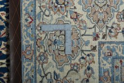 Backside of handmade 1970s Nain rug showing knot structure and weave density