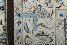 Backside of handmade New Nain rug showing knot structure and weave density