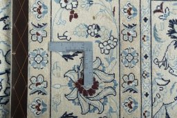 Backside of handmade New Nain rug showing knot structure and weave density