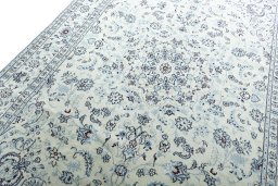 Backside of handmade New Nain rug showing knot structure and weave density