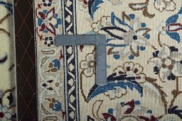 Backside of handmade New Nain rug showing knot structure and weave density