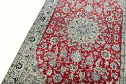 Backside of handmade New Nain rug showing knot structure and weave density