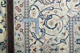 Backside of handmade New Nain rug showing knot structure and weave density